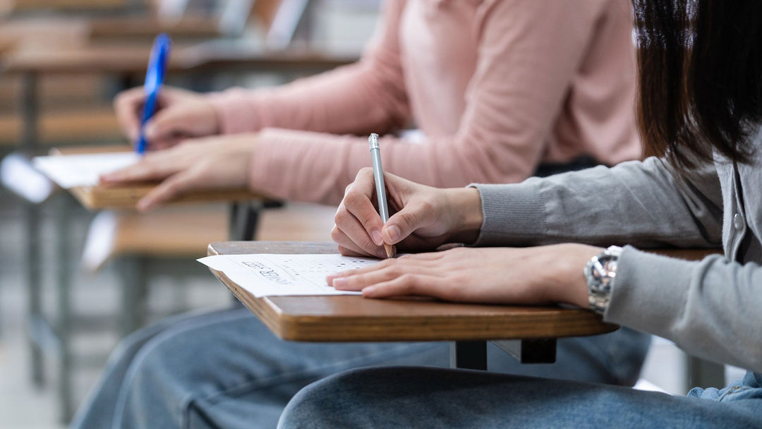 Woman sat at desk with hay fever doing exams